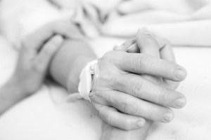person-in-hospital-bed-holding-hands-05